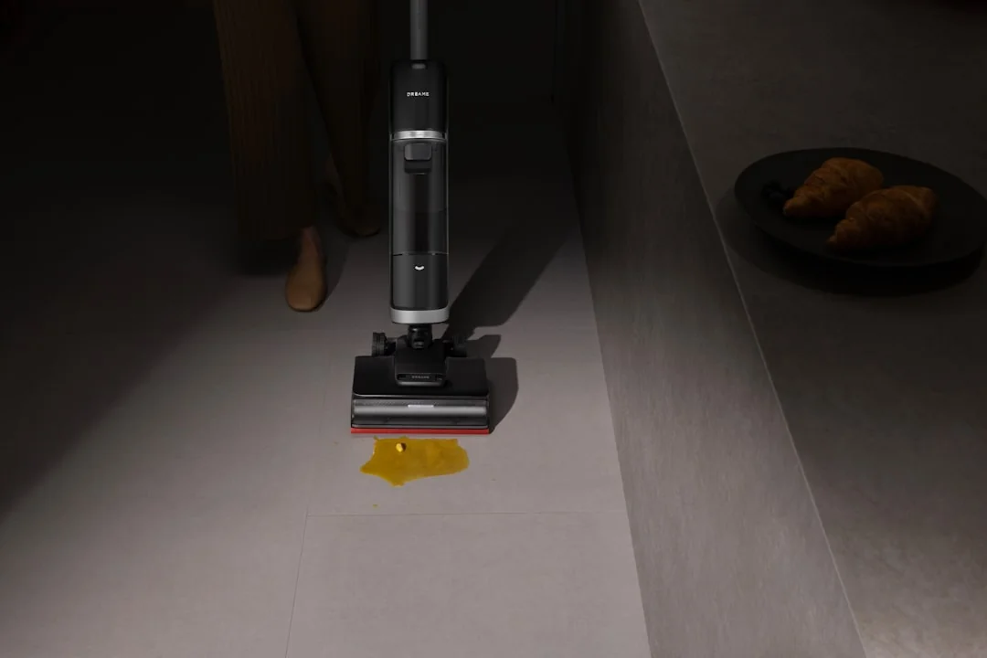Young man engaged in household cleaning, wiping glass panels with a spray bottle.